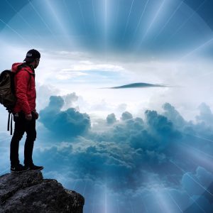 Man on mountain enjoying the views; 10 Ways to Build Resilience 
